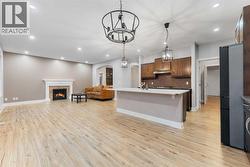 The kitchen features quartz countertops, stainless steel appliances, and a gas cooktop. - 