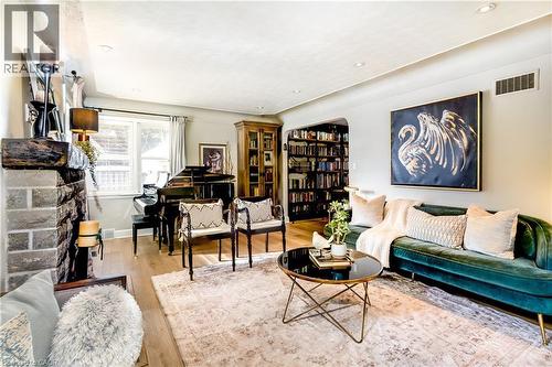 Spacious living room with a cozy wood fireplace - 3 Fallsview Road, Hamilton, ON - Indoor Photo Showing Living Room