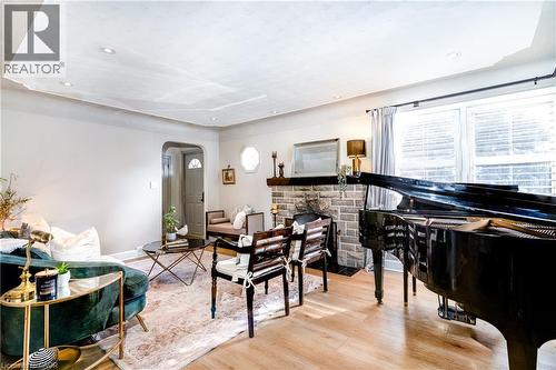 Spacious living room with a cozy wood fireplace - 3 Fallsview Road, Hamilton, ON - Indoor