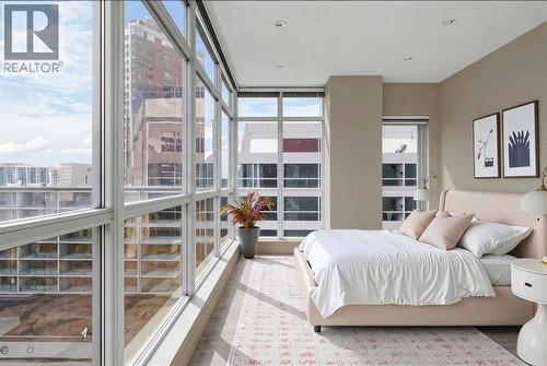 Amazing View with Floor to Ceiling Windows in Bedroom - Virtually Staged - 701, 788 12 Avenue Sw, Calgary, AB - Indoor Photo Showing Bedroom