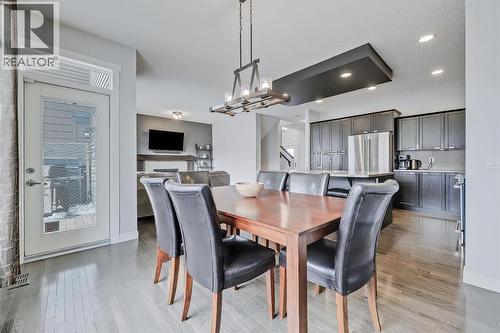 Easy BBQ access to the deck - 9 Copperleaf Way Se, Calgary, AB - Indoor Photo Showing Dining Room
