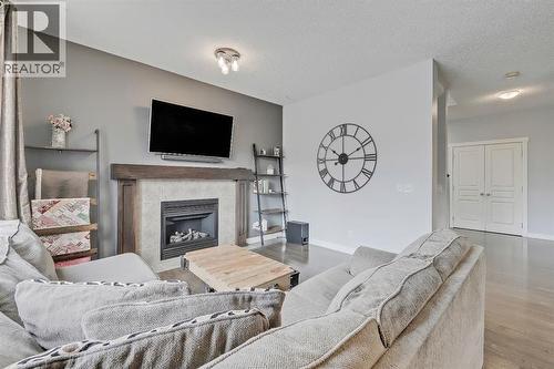 Gas fireplace - 9 Copperleaf Way Se, Calgary, AB - Indoor Photo Showing Living Room With Fireplace