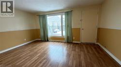 Unfurnished room with wood finished floors and baseboards - 