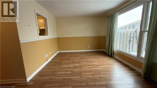 Empty room with light wood-style flooring and a textured ceiling - 66 Glamis Road Unit# 33, Cambridge, ON - Indoor Photo Showing Other Room