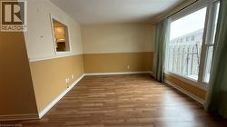 Empty room with light wood-style flooring and a textured ceiling - 