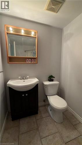 Half bath with vanity and light tile patterned floors - 66 Glamis Road Unit# 33, Cambridge, ON - Indoor Photo Showing Bathroom