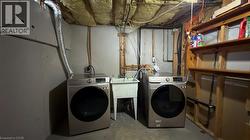 Laundry area with concrete flooring and separate washer and dryer - 