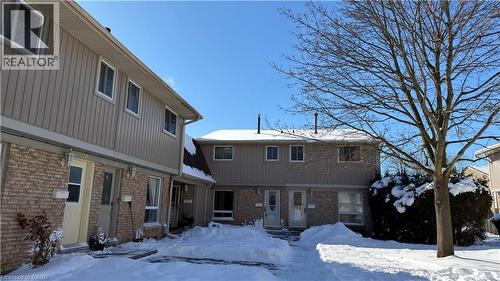 Snow covered property featuring brick siding - 66 Glamis Road Unit# 33, Cambridge, ON - Outdoor