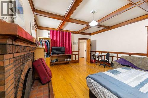 216 15 Avenue Nw, Calgary, AB - Indoor Photo Showing Bedroom With Fireplace