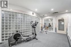 Exercise area featuring tile walls, visible vents, and recessed lighting - 