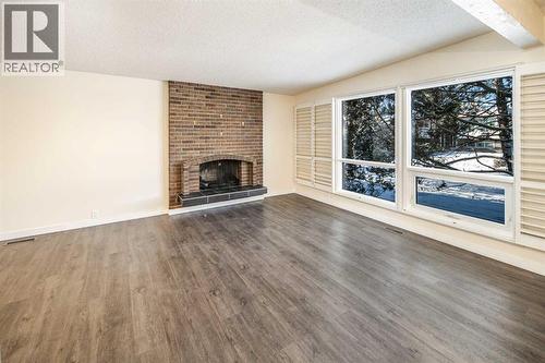 4712 Vegas Road Nw, Calgary, AB - Indoor Photo Showing Living Room With Fireplace