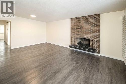 4712 Vegas Road Nw, Calgary, AB - Indoor Photo Showing Living Room With Fireplace