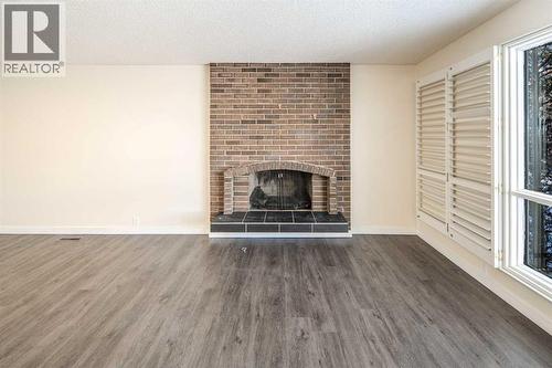 4712 Vegas Road Nw, Calgary, AB - Indoor Photo Showing Living Room With Fireplace