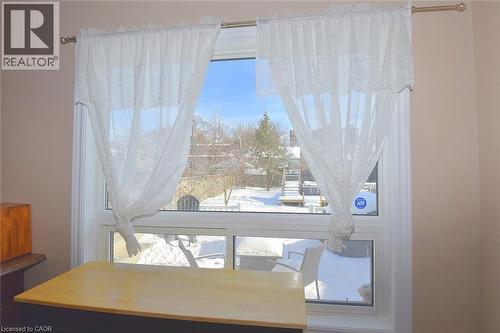 Peeking out of kitchen window - 19 East 17Th Street, Hamilton, ON - Indoor Photo Showing Other Room