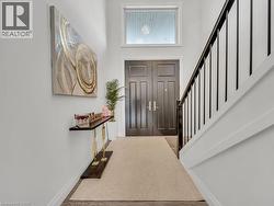 Foyer entrance featuring baseboards and stairs - 