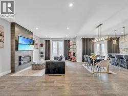 Living area with light wood-style flooring, a fireplace, and recessed lighting - 
