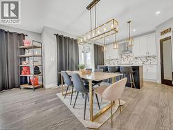Dining area with light wood-style floors and recessed lighting - 