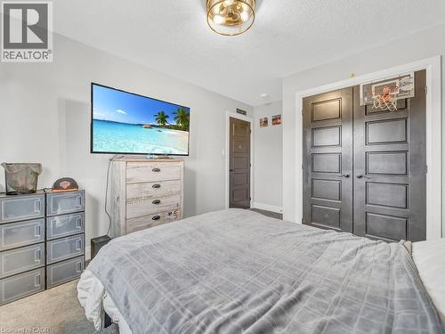 Carpeted bedroom with a closet and a textured ceiling - 3374 Oriole Drive, London, ON - Indoor Photo Showing Bedroom