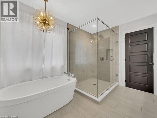 Bathroom with a shower stall, a chandelier, a freestanding bath, and recessed lighting - 3374 Oriole Drive, London, ON - Indoor Photo Showing Bathroom
