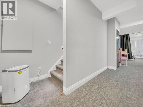 Below grade area featuring light colored carpet and stairs - 3374 Oriole Drive, London, ON - Indoor Photo Showing Other Room