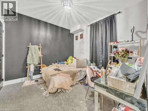 Bedroom with a chandelier - 3374 Oriole Drive, London, ON - Indoor Photo Showing Bedroom
