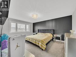 Bedroom featuring carpet floors and a chandelier - 
