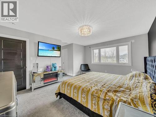 Bedroom with light colored carpet and a chandelier - 3374 Oriole Drive, London, ON - Indoor Photo Showing Bedroom