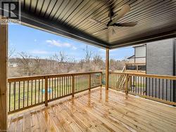 Wooden terrace featuring a ceiling fan - 