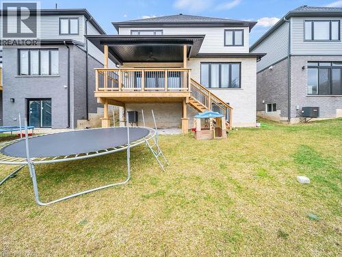 Back of property featuring a trampoline, stairs, and a yard - 3374 Oriole Drive, London, ON - Outdoor