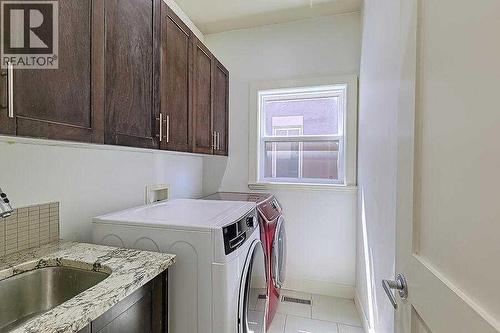 16 Rockcliff Point Nw, Calgary, AB - Indoor Photo Showing Laundry Room