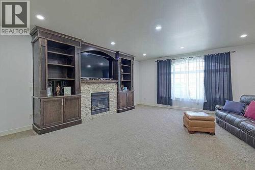 16 Rockcliff Point Nw, Calgary, AB - Indoor Photo Showing Other Room With Fireplace