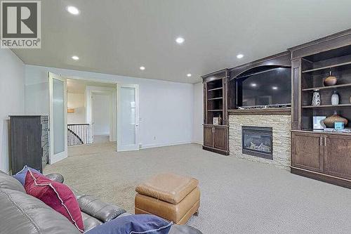 16 Rockcliff Point Nw, Calgary, AB - Indoor Photo Showing Other Room With Fireplace