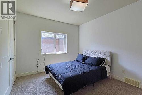 16 Rockcliff Point Nw, Calgary, AB - Indoor Photo Showing Bedroom