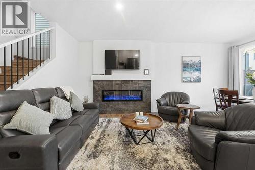 102 Setonstone Manor Se, Calgary, AB - Indoor Photo Showing Living Room With Fireplace