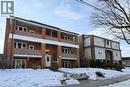 Snow covered property with a view of apartment building / complex - 17 Louisa Street, Kitchener, ON  - Outdoor With Facade 