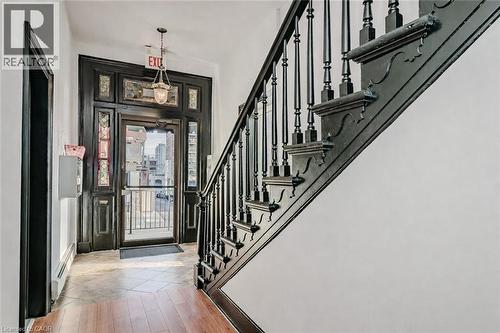 Foyer featuring stairs, a baseboard radiator, and light wood-type flooring - 14 Forest Avenue, Hamilton, ON - Indoor Photo Showing Other Room