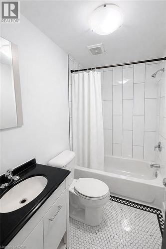 Full bath featuring vanity, shower / tub combo, and light tile patterned flooring - 112 Margaret Avenue, Kitchener, ON - Indoor Photo Showing Bathroom