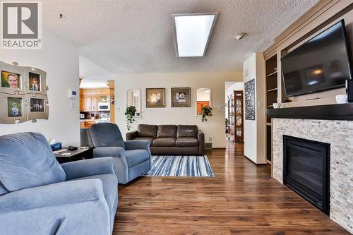 1813 Elm Road S, Lethbridge, AB - Indoor Photo Showing Living Room With Fireplace