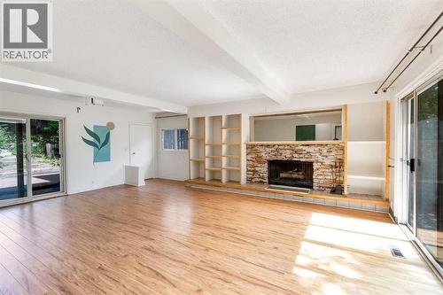 Living room - 4908 23 Avenue Nw, Calgary, AB - Indoor Photo Showing Living Room With Fireplace