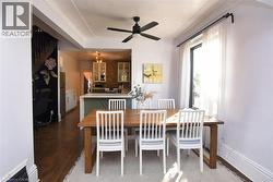 Dining space featuring ceiling fan and dark wood-type flooring - 