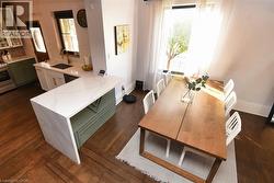 Dining room featuring baseboards and dark wood-type flooring - 