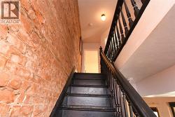 Stairs featuring brick wall - 
