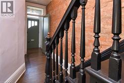 Stairs with brick wall and wood finished floors - 
