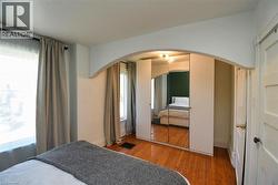 Bedroom with hardwood / wood-style floors and a closet - 