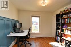 Office with baseboards and light wood-type flooring - 