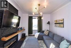 Living area with wood finished floors and a fireplace - 