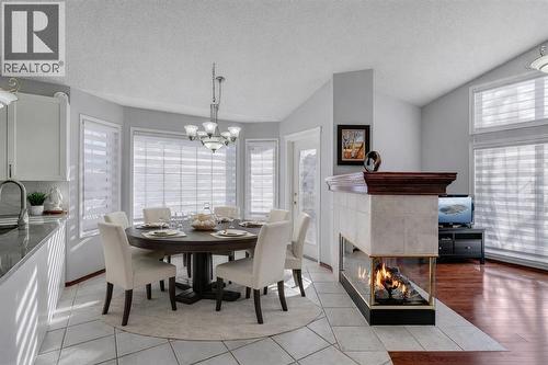 78 Mckenzie Lake Place Se, Calgary, AB - Indoor Photo Showing Dining Room With Fireplace