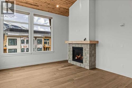 407, 1505 Spring Creek Gate, Canmore, AB - Indoor Photo Showing Other Room With Fireplace