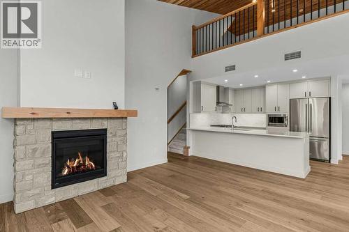 407, 1505 Spring Creek Gate, Canmore, AB - Indoor Photo Showing Living Room With Fireplace