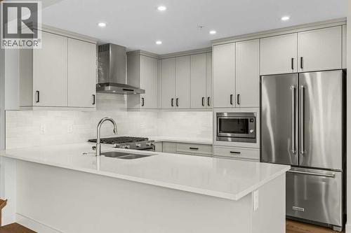 407, 1505 Spring Creek Gate, Canmore, AB - Indoor Photo Showing Kitchen With Double Sink With Upgraded Kitchen